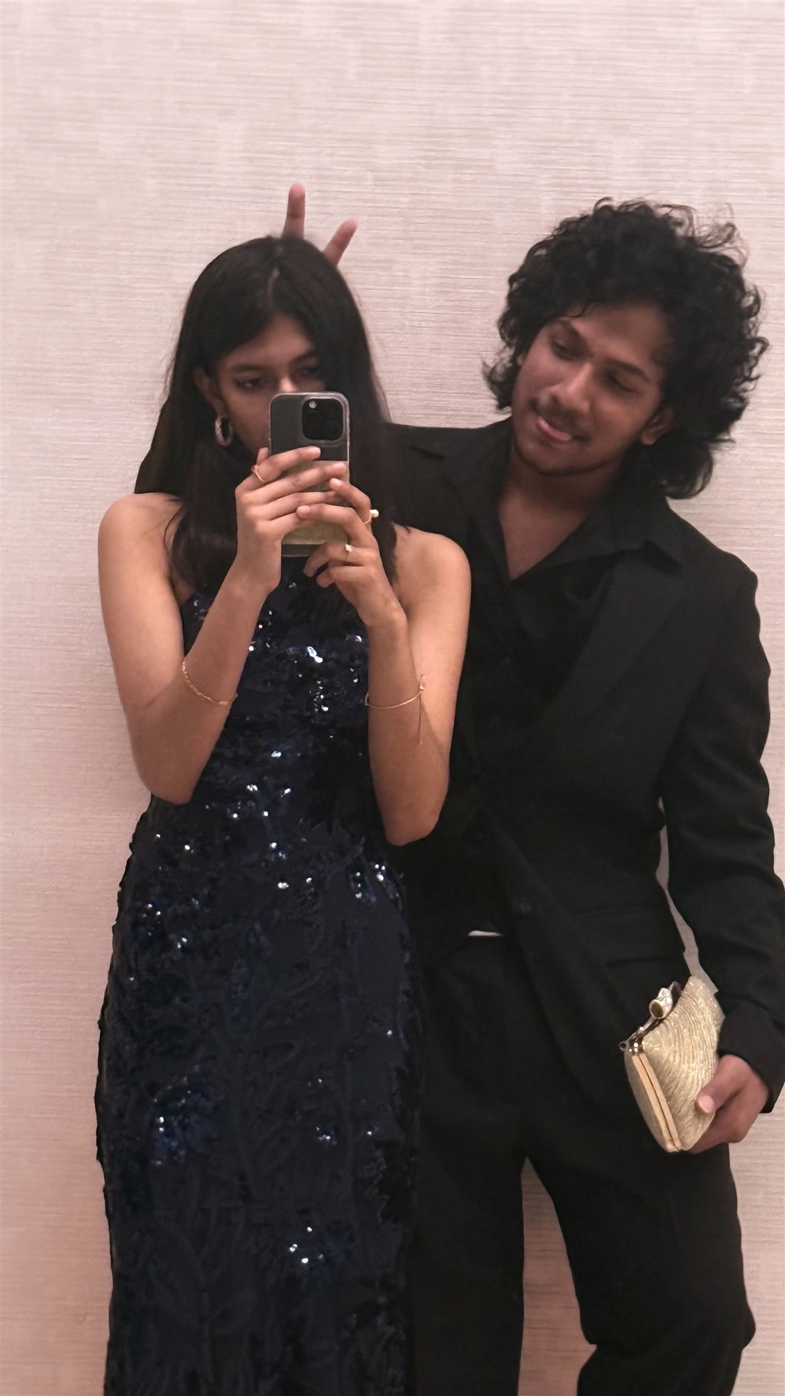Our prom outfits in a goofy mirror selfie